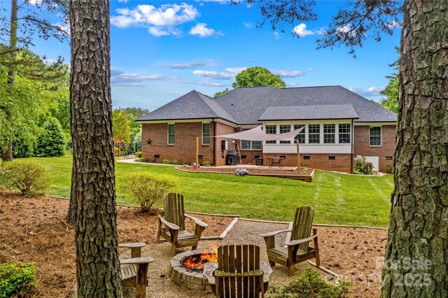 4159 Isle Of Pines Dr, Denver, NC 28037 - rear view of house with an outdoor fire pit, crawl space, and a lawn