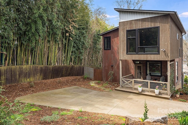 exterior space with a patio area, a porch, and fence