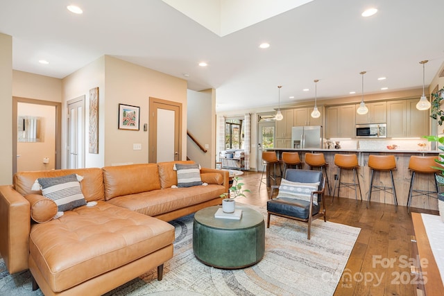 living area featuring wood-type flooring, recessed lighting, and stairway
