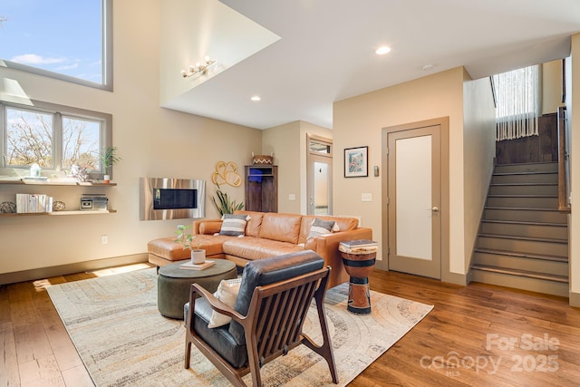 living room featuring recessed lighting, stairs, baseboards, and hardwood / wood-style floors