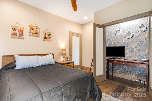 bedroom with baseboards, a ceiling fan, and wood finished floors