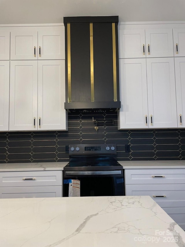 27 George Allen Rdg, Arden, NC 28704 - kitchen featuring electric range, decorative backsplash, white cabinetry, and exhaust hood