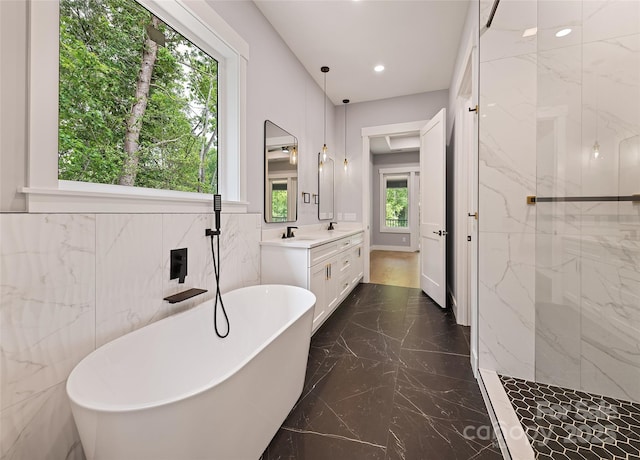 27 George Allen Rdg, Arden, NC 28704 - bathroom with marble tiled floors, a freestanding bath, double vanity, a marble finish shower, and recessed lighting