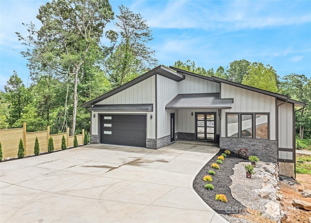 27 George Allen Rdg, Arden, NC 28704 - view of front of house featuring stone siding, french doors, a garage, and concrete driveway