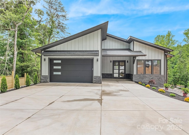 27 George Allen Rdg, Arden, NC 28704 - view of front facade with stone siding, an attached garage, and concrete driveway