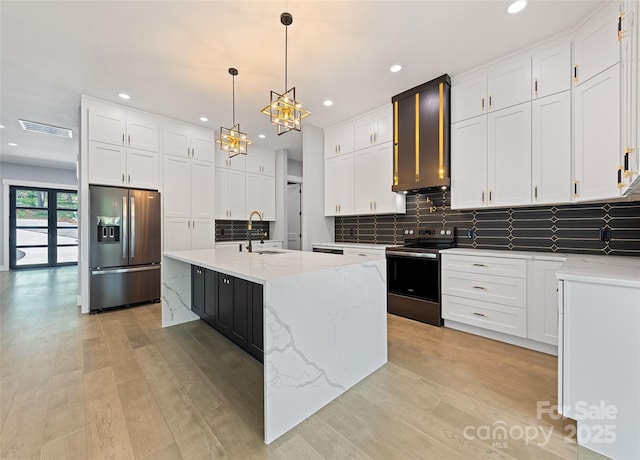 27 George Allen Rdg, Arden, NC 28704 - kitchen featuring appliances with stainless steel finishes, light wood finished floors, tasteful backsplash, white cabinets, and recessed lighting