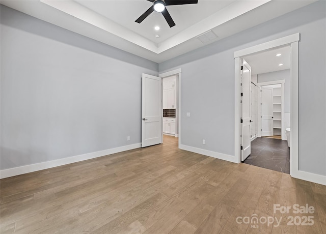 27 George Allen Rdg, Arden, NC 28704 - unfurnished bedroom with wood finished floors, a spacious closet, ceiling fan, recessed lighting, and a raised ceiling