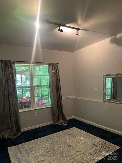 8619 Delamere Ln, Charlotte, NC 28269 - spare room with rail lighting and baseboards