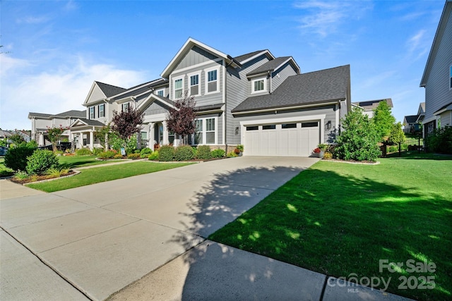view of front facade with a front yard, an attached garage, board and batten siding, and concrete driveway