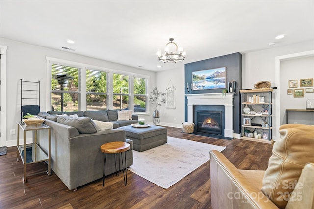 living area with visible vents, a notable chandelier, recessed lighting, and dark wood finished floors