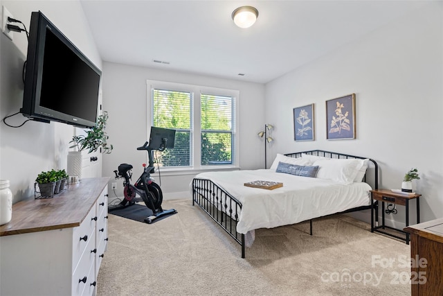 carpeted bedroom featuring baseboards and visible vents