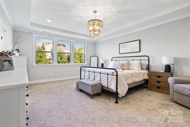 bedroom featuring a raised ceiling, baseboards, light colored carpet, ornamental molding, and an inviting chandelier