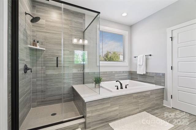 bathroom with a stall shower and a bath