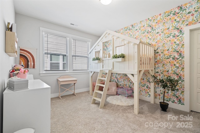 carpeted bedroom with wallpapered walls, baseboards, and visible vents