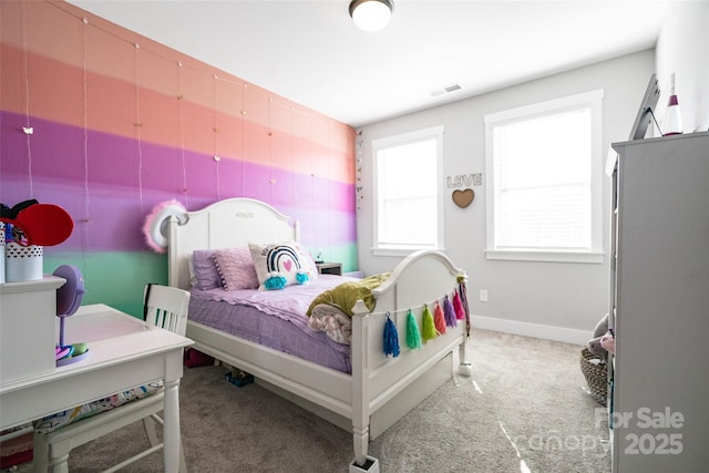 bedroom featuring baseboards, light colored carpet, and visible vents