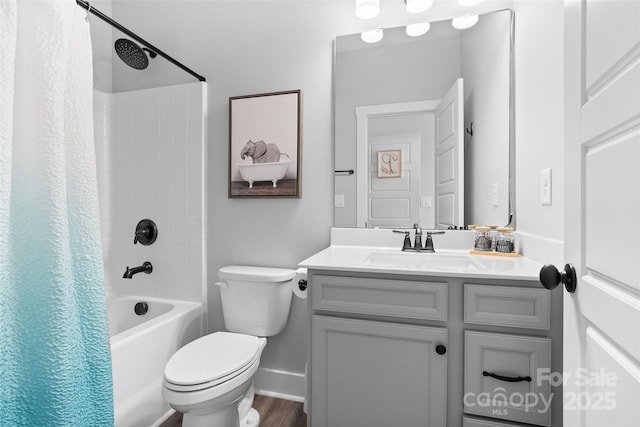 full bath featuring vanity, toilet, baseboards, shower / bath combo, and wood finished floors
