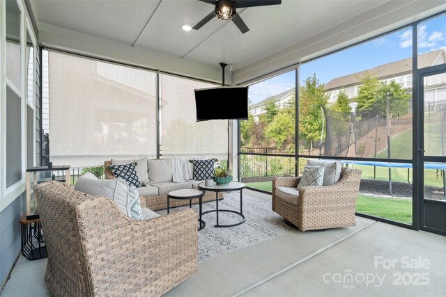 sunroom / solarium featuring an outdoor living space and ceiling fan