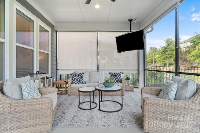 sunroom / solarium with an outdoor living space, ceiling fan, and a healthy amount of sunlight