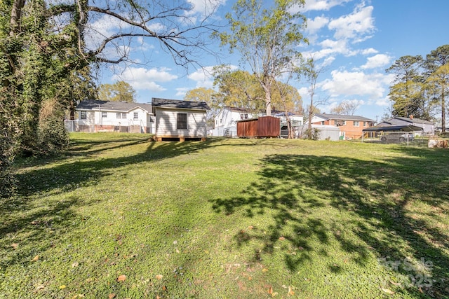 view of yard featuring an outbuilding and fence