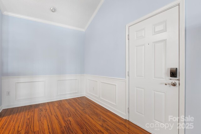 1000 Olde Eastwood Village Blvd Unit 307, Asheville, NC 28803 - unfurnished room featuring dark wood-style floors, ornamental molding, and wainscoting