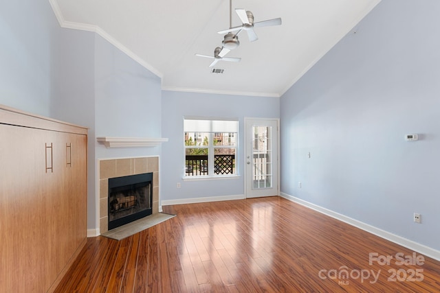 1000 Olde Eastwood Village Blvd Unit 307, Asheville, NC 28803 - unfurnished living room featuring visible vents, a tile fireplace, ornamental molding, wood finished floors, and a ceiling fan