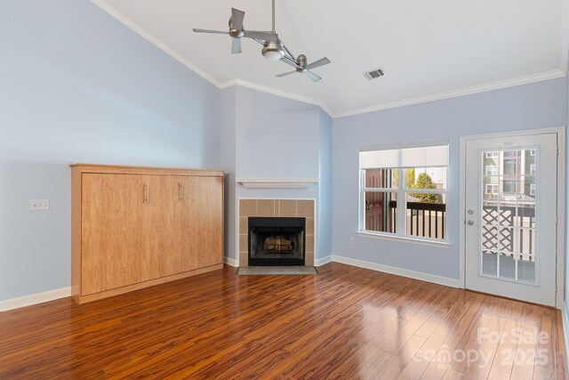 1000 Olde Eastwood Village Blvd Unit 307, Asheville, NC 28803 - unfurnished living room with crown molding, a tile fireplace, a ceiling fan, wood finished floors, and baseboards