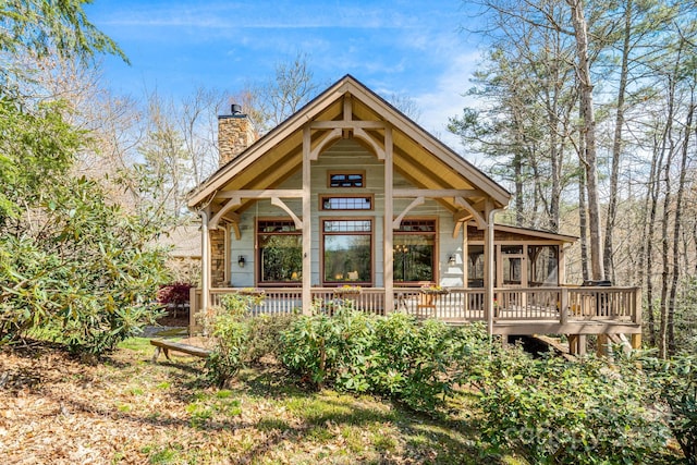 exterior space with a porch and a chimney
