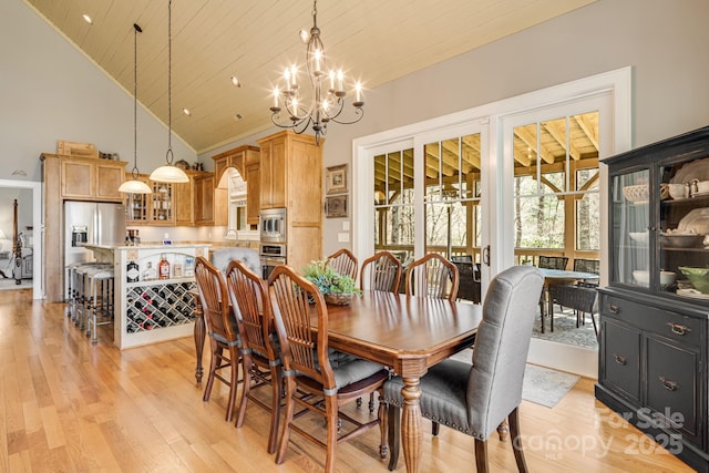 dining room with high vaulted ceiling, wood ceiling, light wood-type flooring, and a chandelier