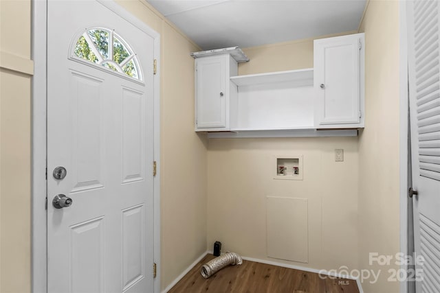 clothes washing area with baseboards, wood finished floors, cabinet space, and hookup for a washing machine
