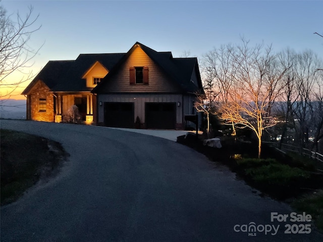 view of front of house featuring aphalt driveway and a garage