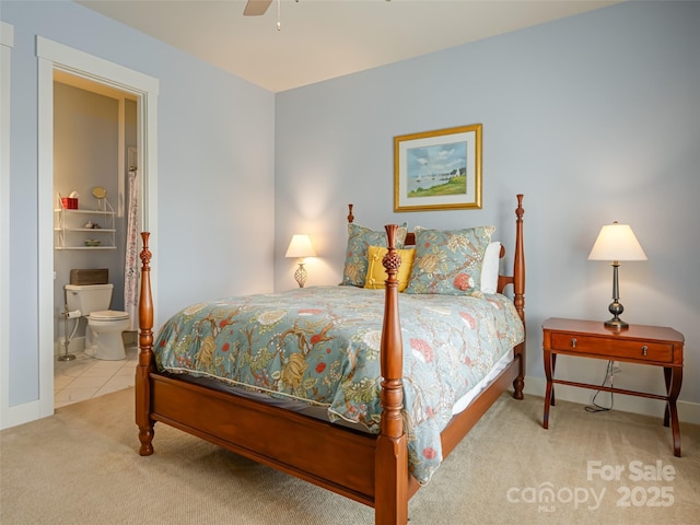 bedroom with connected bathroom, ceiling fan, and carpet flooring