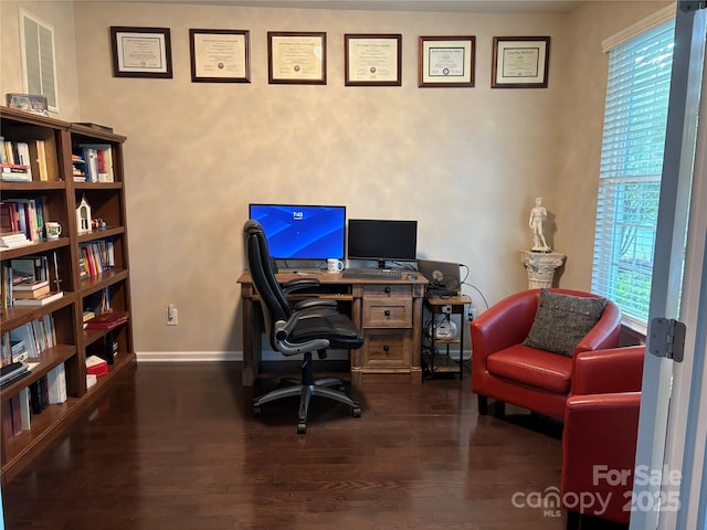 office space with baseboards and wood finished floors