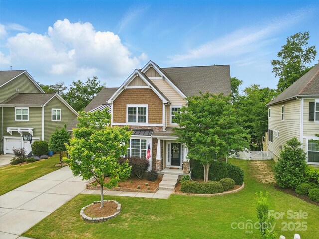 1224 Screech Owl Rd, Waxhaw, NC 28173 - craftsman-style house with driveway, board and batten siding, and stone siding