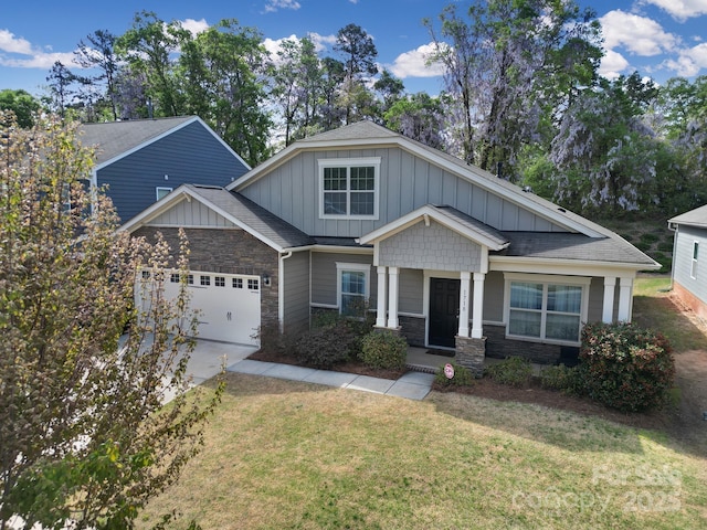 1718 Still River Way, Fort Mill, SC 29708 - craftsman house featuring board and batten siding, stone siding, a front lawn, an attached garage, and driveway