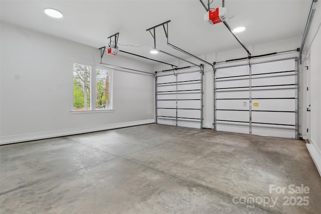 garage with baseboards and a garage door opener