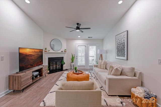17143 Red Feather Dr, Charlotte, NC 28277 - living room with a fireplace with flush hearth, baseboards, light wood-style floors, ceiling fan, and recessed lighting