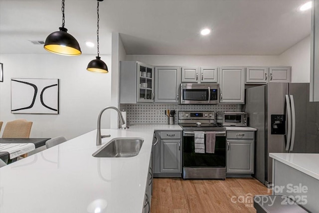 17143 Red Feather Dr, Charlotte, NC 28277 - kitchen with gray cabinets, appliances with stainless steel finishes, light wood finished floors, and visible vents