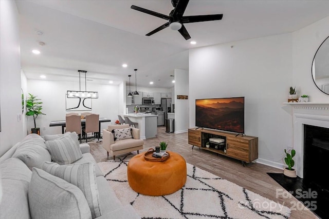 17143 Red Feather Dr, Charlotte, NC 28277 - living area featuring light wood-type flooring, recessed lighting, a fireplace with flush hearth, baseboards, and ceiling fan