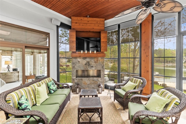 19040 Mary Ardrey Cir, Cornelius, NC 28031 - sunroom with wood ceiling, an outdoor living space with a fireplace, ceiling fan, and a water view