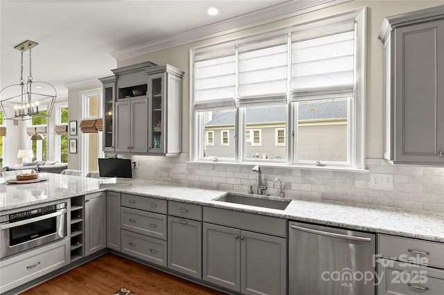 19040 Mary Ardrey Cir, Cornelius, NC 28031 - kitchen with appliances with stainless steel finishes, gray cabinetry, a sink, backsplash, and ornamental molding