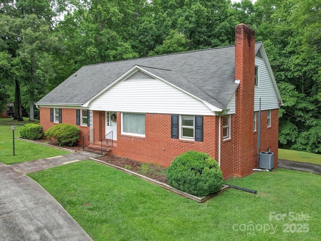 167 Cedar Ln, Troutman, NC 28166 - view of front facade with brick siding, a chimney, a front lawn, and a shingled roof
