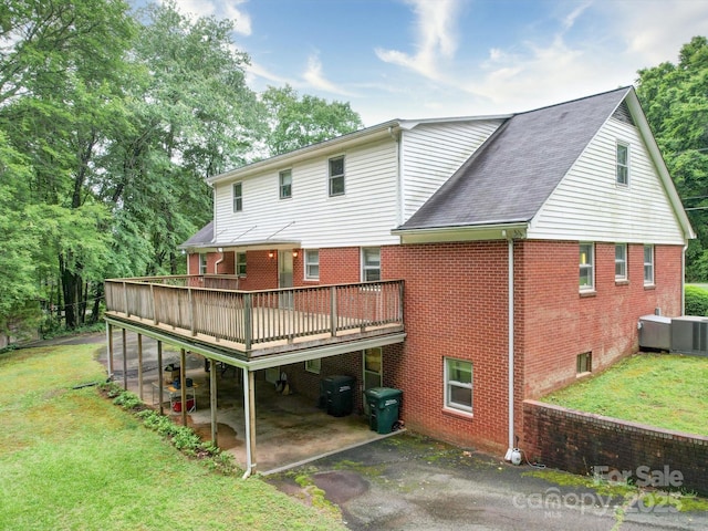 167 Cedar Ln, Troutman, NC 28166 - back of house with brick siding, a patio area, a wooden deck, a lawn, and driveway