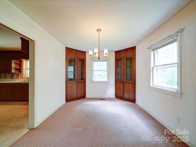 167 Cedar Ln, Troutman, NC 28166 - unfurnished dining area featuring a chandelier, carpet flooring, and baseboards
