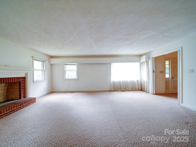 167 Cedar Ln, Troutman, NC 28166 - unfurnished living room featuring carpet, a brick fireplace, baseboards, and a textured ceiling