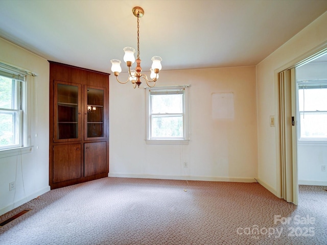 167 Cedar Ln, Troutman, NC 28166 - unfurnished room featuring a chandelier, plenty of natural light, and light carpet