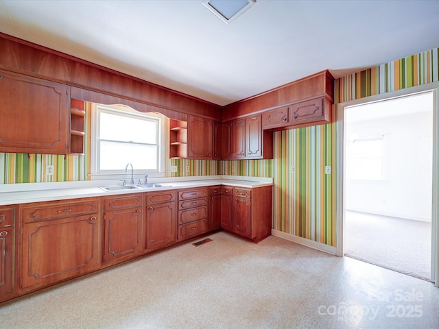 167 Cedar Ln, Troutman, NC 28166 - kitchen with a sink, wallpapered walls, open shelves, light countertops, and baseboards