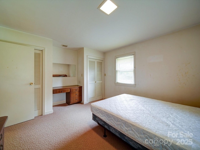 167 Cedar Ln, Troutman, NC 28166 - bedroom featuring two closets, light colored carpet, and a desk