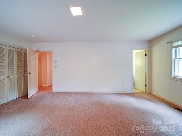 167 Cedar Ln, Troutman, NC 28166 - unfurnished bedroom with light carpet, ensuite bath, and baseboards