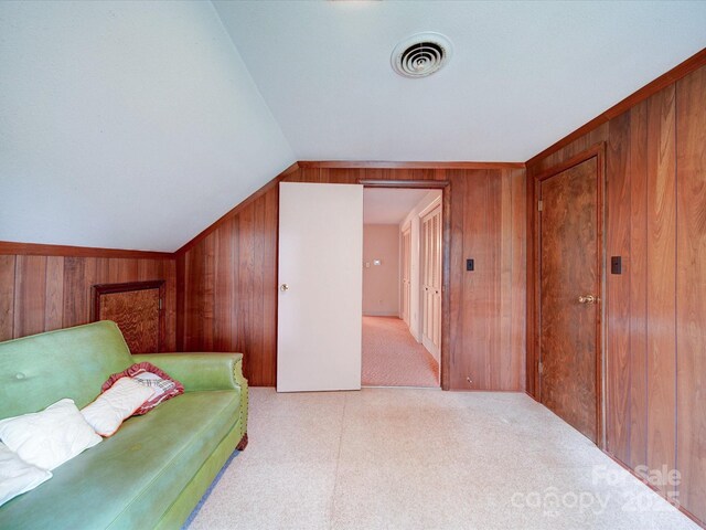 167 Cedar Ln, Troutman, NC 28166 - living area with wooden walls, carpet flooring, and vaulted ceiling