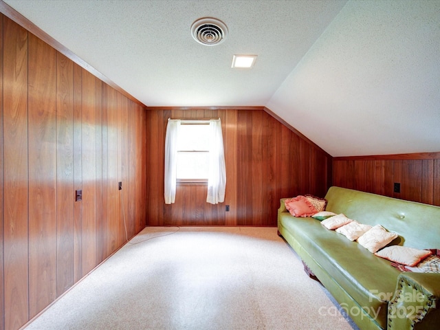 167 Cedar Ln, Troutman, NC 28166 - carpeted bedroom featuring wooden walls, a textured ceiling, and lofted ceiling